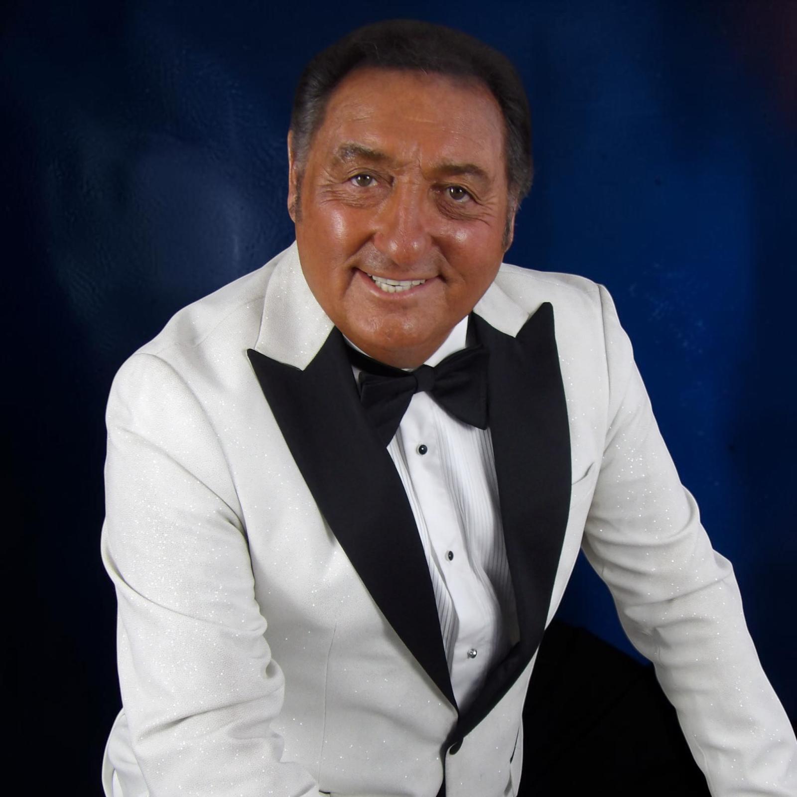 Gary Anders, Voice of the Legends in a white tuxedo jacket